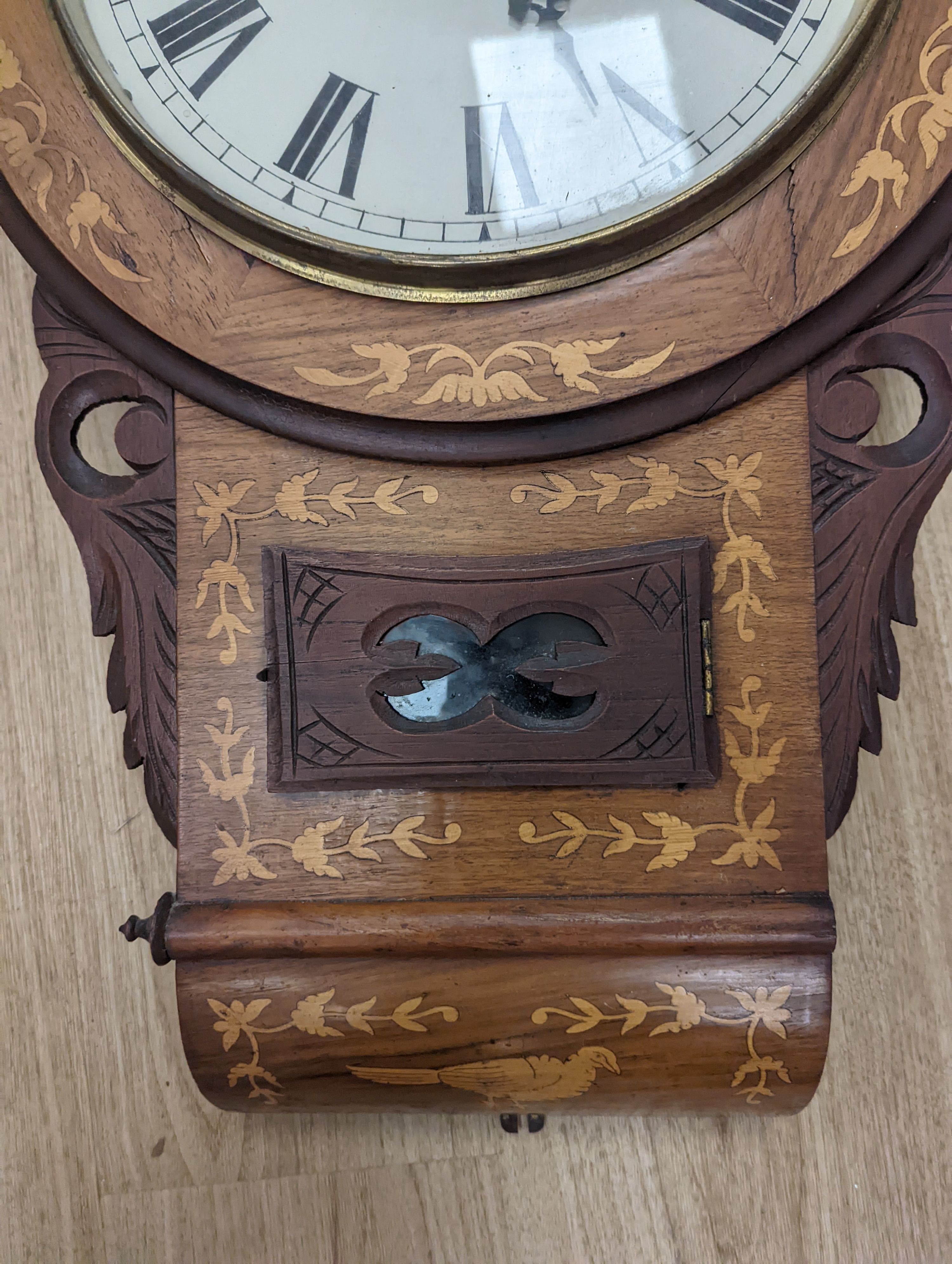 An American marquetry drop dial wall clock, 27cm enamelled dial, with key and pendulum